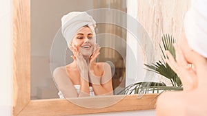 A young smiling woman takes care of her skin and hair after a shower. Spa treatments at home, skin care. Web banner