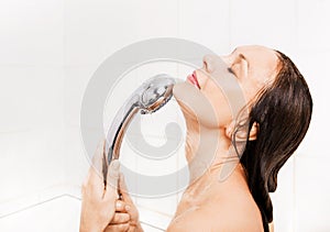 Young smiling woman taking a shower