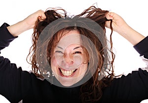 Young smiling woman tearing her hair