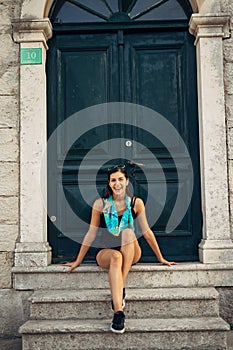 Young smiling woman travelling and visiting Europe.Summer touring Europe and Mediterranean culture.Colourful streets,old photo