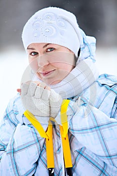 Young smiling woman warming fingers