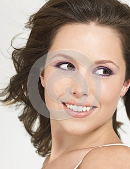 Young Smiling Woman with wind-swept hair close up