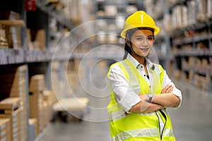 Young smiling woman worker and vest checking box in stock in  factory warehouse, Staff check stock girl prepares shipping goods