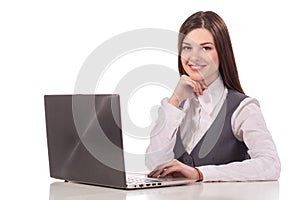 Young smiling woman working on laptop isolated