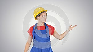 Young smiling worker woman talking and showing objects to her si