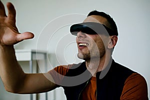 Young Man Wearing Virtual Reality. Man Playing Video Games Virtual Reality Glasses In His Apartment.