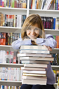 Young smilling woman sitting in the library