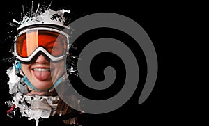 A young snowboard girl wearing a helmet and glasses put out her tongue. On a black background