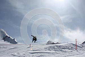 Young snowboarder man doing ski jump.