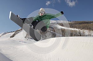 Young Snowboarder Performing Stunts On Snowy Hill