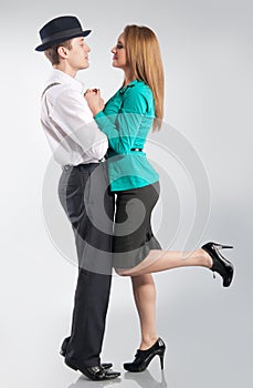 Young snuggling couple on the gray background photo