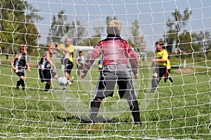 Young Soccer Goalie thru Netting