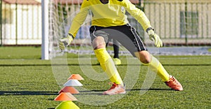 Young Soccer Goalie in Training Action. Boy Soccer Player Improving Speed Skills