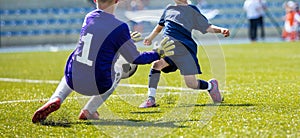 Young soccer goalkeeper save. Boy catching soccer ball