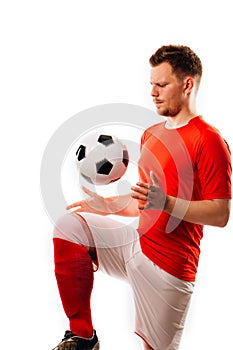 Young soccer player with ball on black background in studio. photo