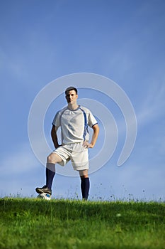 Young soccer player on green grass