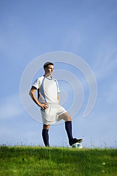 Young soccer player on green grass