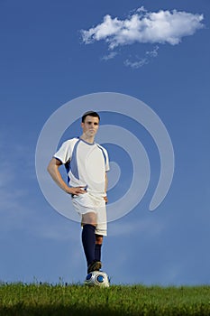 Young soccer player on green grass