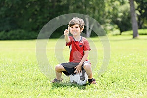 Young soccer player having fun on a field with ball