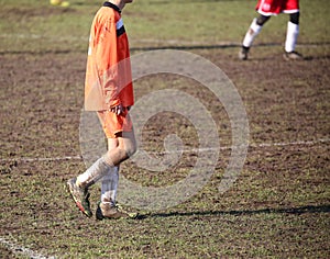 Young soccer player in the mud