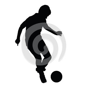 Young soccer player passes the ball silhouette