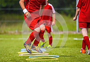 Young Soccer Player Practicing on the Pitch. Soccer Football Equpment. Dynamic Jumping Football Practice