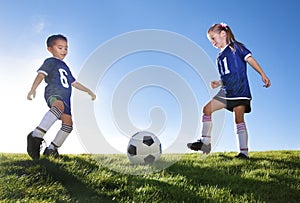 Young Soccer Players Kicking Ball