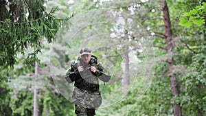 Young soldier with backpack in forest