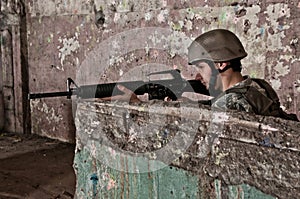 Young soldier behind obstacle