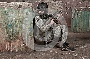 Young soldier behind obstacle