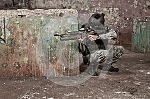 Young soldier behind obstacle