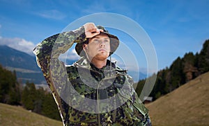 Young soldier in military uniform outdoors