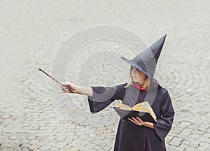 Young sorceress in the castle conjuring by magic wand