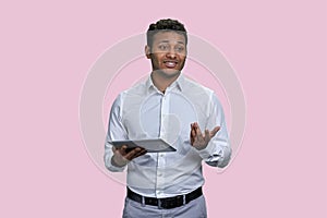 Young southeast asian man giving a speech using tablet pc.