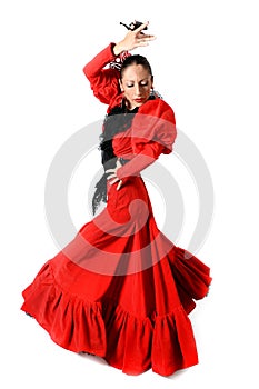 Young Spanish woman dancing flamenco with castanets in her hands photo