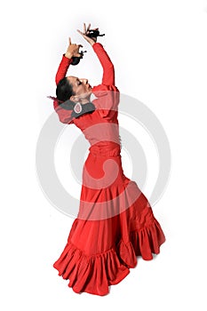 Young Spanish woman dancing flamenco with castanets in her hands