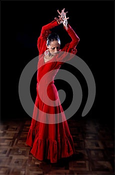 Young Spanish woman dancing flamenco in traditional red dress