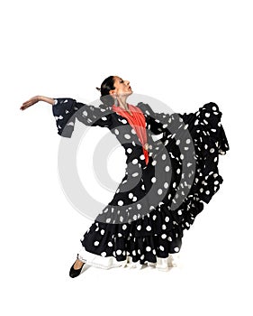 Young Spanish woman dancing flamenco in typical folk dress