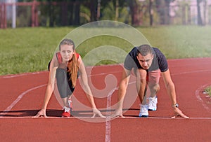 Young sport couple in starting position prepared to compete