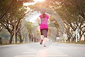 Young sport girl runner athlete running at road. Sport  and exercise concept