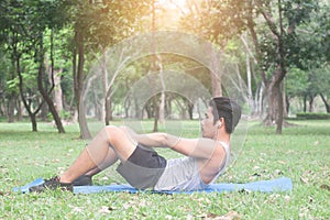 Young sport man exercising before jogging-outside in nature