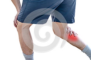 Young sport man with strong athletic legs holding knee