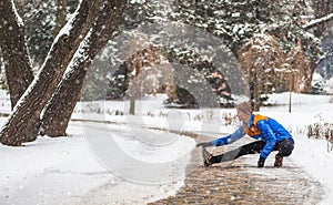 Young sport woman doing exercises during winter training outside in cold snow weather