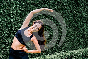 Young sport woman doing morning exercise in park.