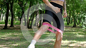 Young sport woman engaged gymnastics or stretching use resistance band.