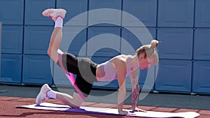 Young sport woman engaged gymnastics or stretching use resistance band.