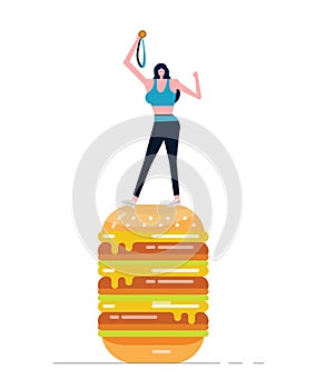 Young sport woman holding gold medal standing on big burger.
