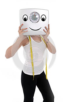 Young sport woman holding scale happy face