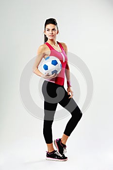 Young sport woman with soccer ball