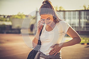 Young sport woman talking phone.